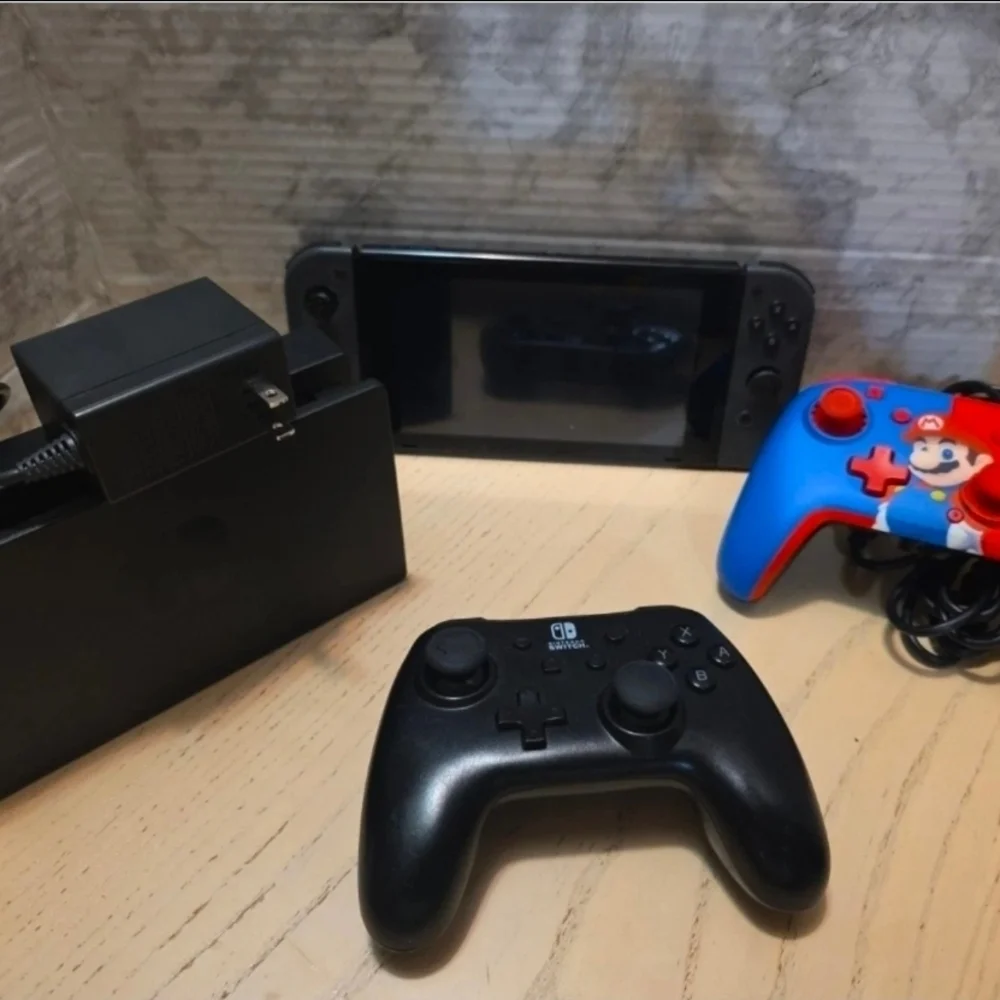 Nintendo Switch with Black Pro Controller and Blue Red Wired Controller